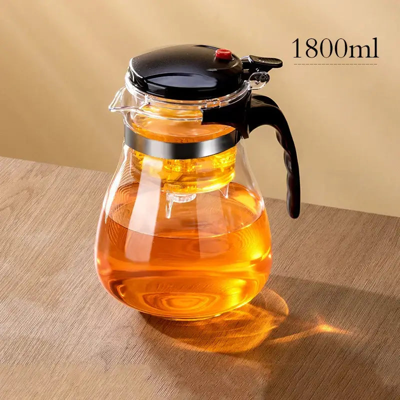 DecorBites glass teapot with one-button filtering system features clear glass body and black lid handle with silver band