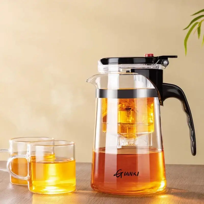 Clear glass decorbites glass teapot with black lid and handle featuring one-button filtration for tea brewing