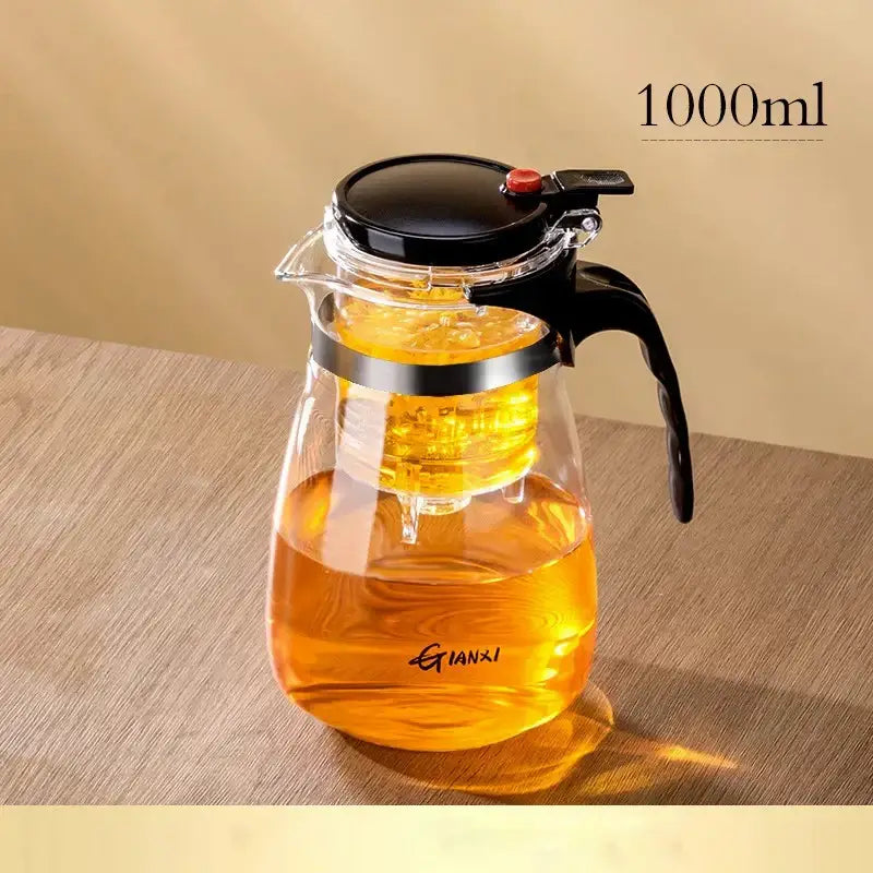 Clear glass DecorBites glass teapot with black lid and handle, one-button filtration for tea brewing of golden-brown tea