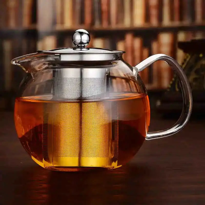 Clear borosilicate glass teapot with stainless steel infuser and amber tea by DecorBites™ heat resistant flower tea pot