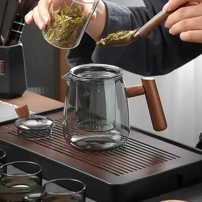 Clear glass DecorBites glass teapot with wooden handle and lid featuring modern design for Chinese tea ceremony