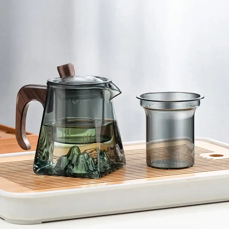 Transparent decorbites glass teapot with wooden handle and lid featuring mountain landscape inside for kung fu tea brewing