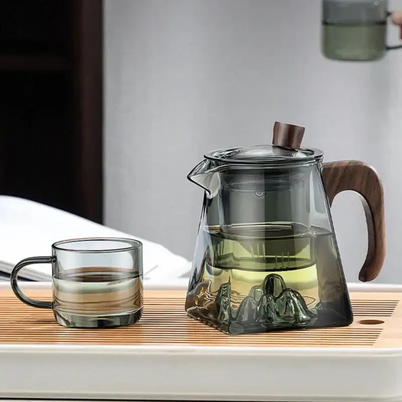 Decorbites glass teapot with wooden handle and lid knob featuring transparent heat resistant glass and embossed mountain design
