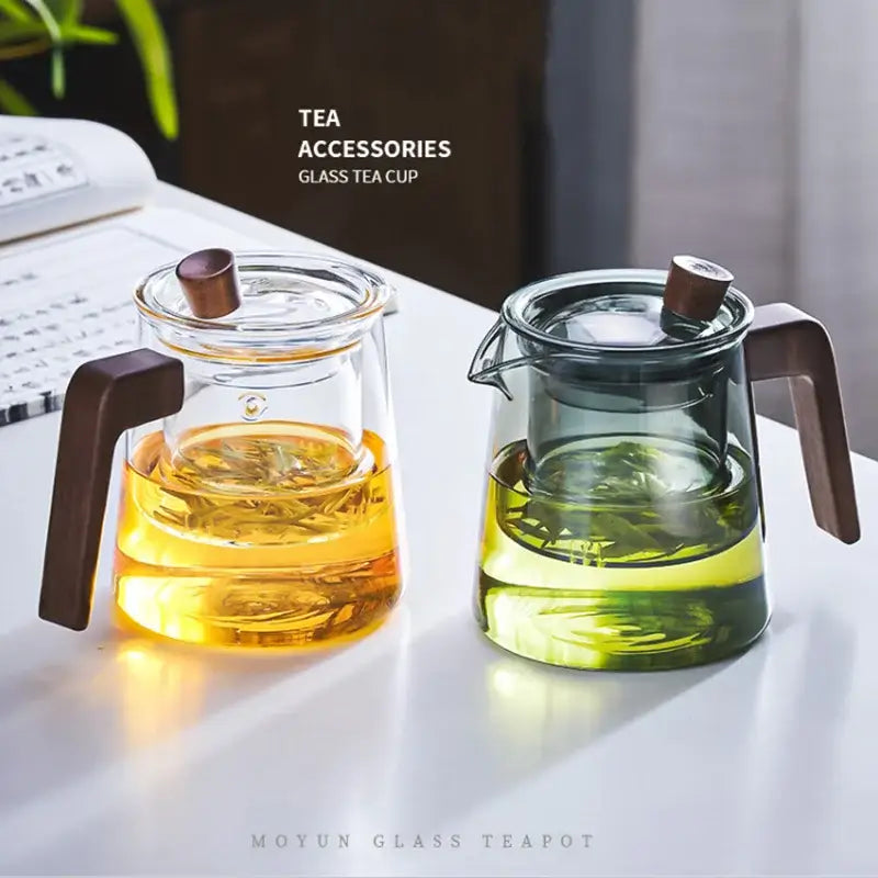 Clear glass DecorBites glass teapot set with dark brown wood handle and lid featuring amber and green tea