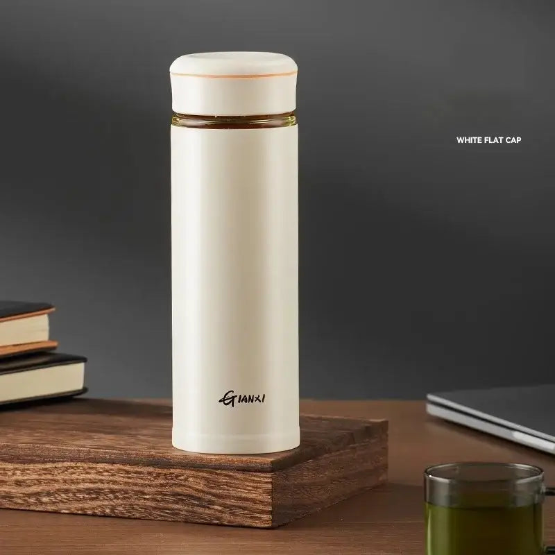 Cream-colored stainless steel thermos cup with tea separation feature and gold accent band by qianxi for office use