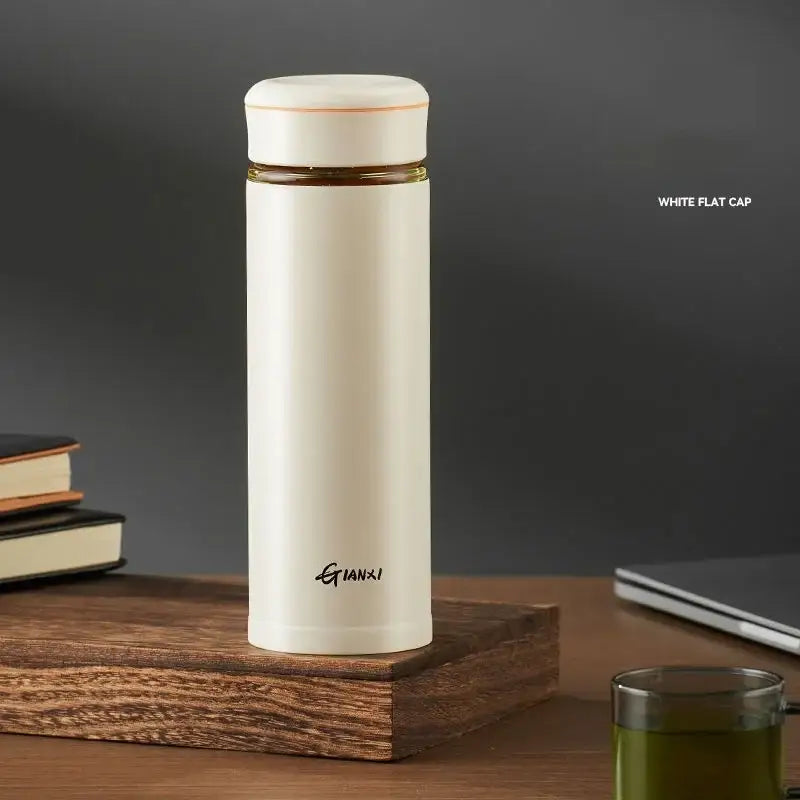 Cream-colored stainless steel thermos cup with tea separation feature and gold accent from DecorBites™ office set