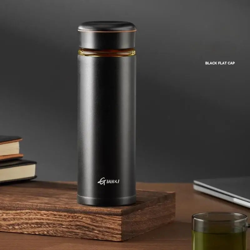Black stainless steel thermos cup with tea separation feature and gold accent band featuring gianxi logo