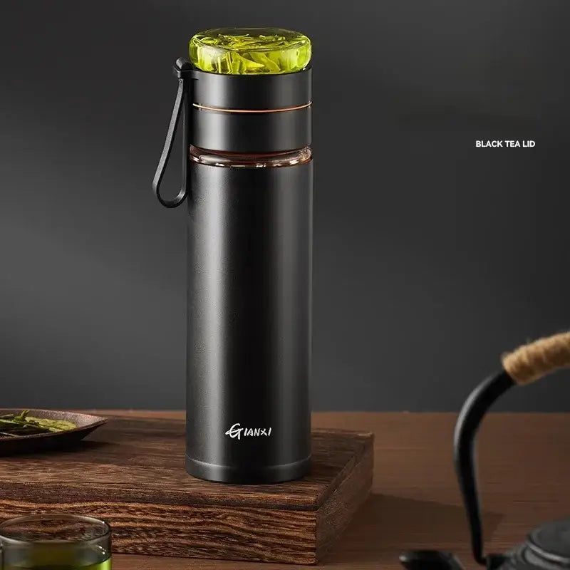 Black insulated stainless steel thermos cup with vibrant green glass lid and tea separation for office use