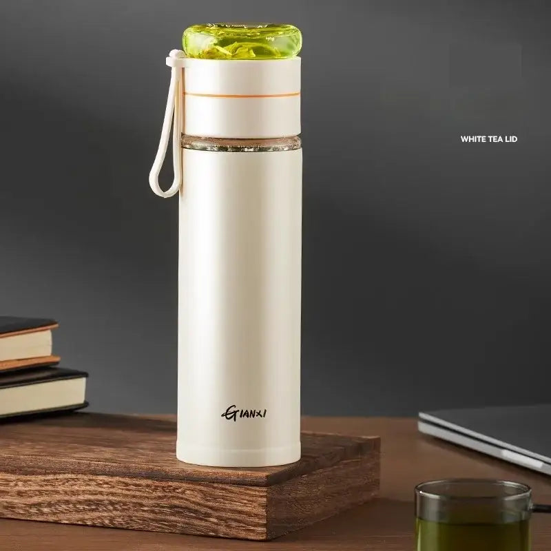 Cream-colored stainless steel thermos cup with tea separation feature lime green lid and gianki logo for office use
