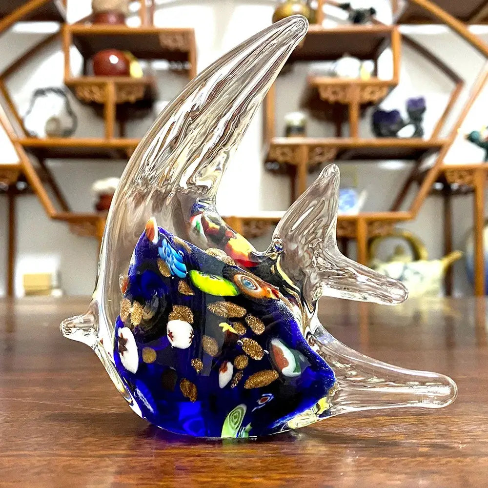 A decorbites glass tropical fish figurine featuring a vibrant blue translucent body with colorful mosaic patterns and gold flecks