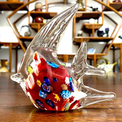 A vibrant red decorbites glass tropical fish figurine with intricate blue yellow and white floral inlays for home décor