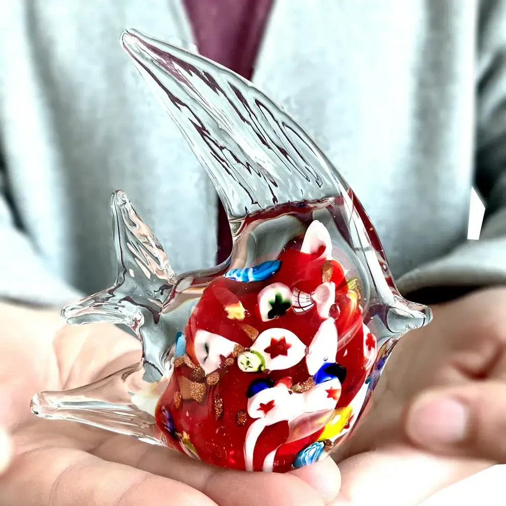 A vibrant red decorbites glass tropical fish figurine with clear fins and colorful embedded patterns for home décor
