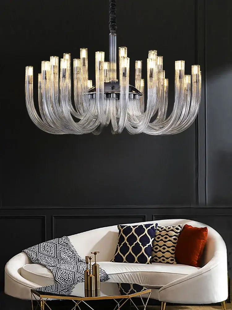 A decorbites glass tube dining chandelier with clear curved glass arms and a central chrome fixture for modern lamps