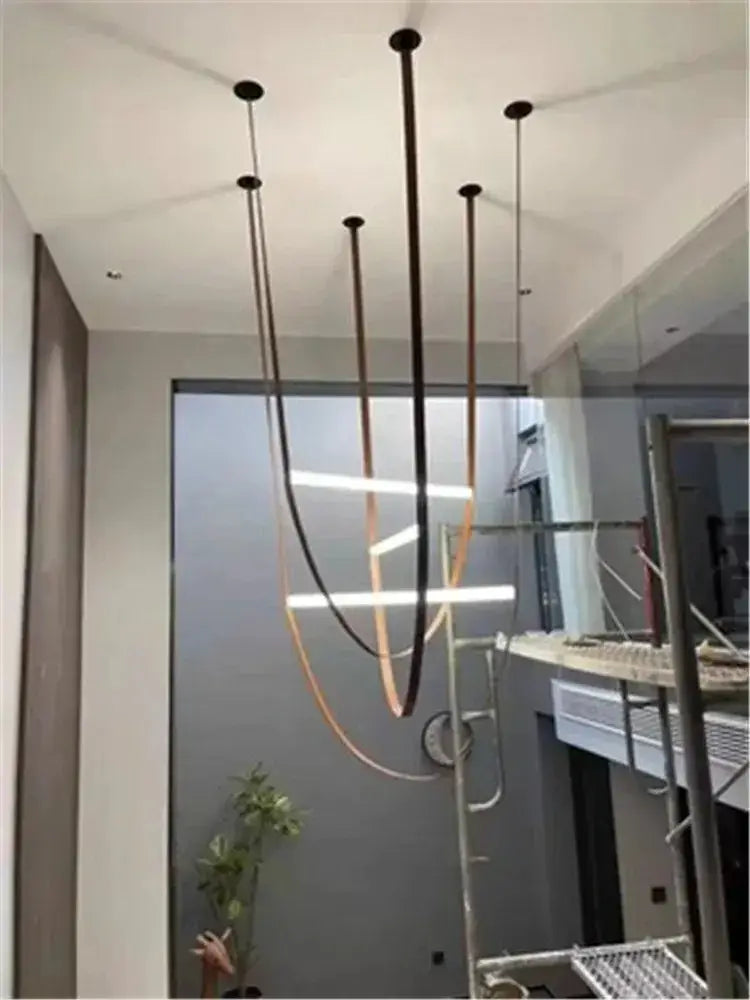 Decorbites glass tube pendant lamp with slender curved black and bronze metal rods for modern living room lighting