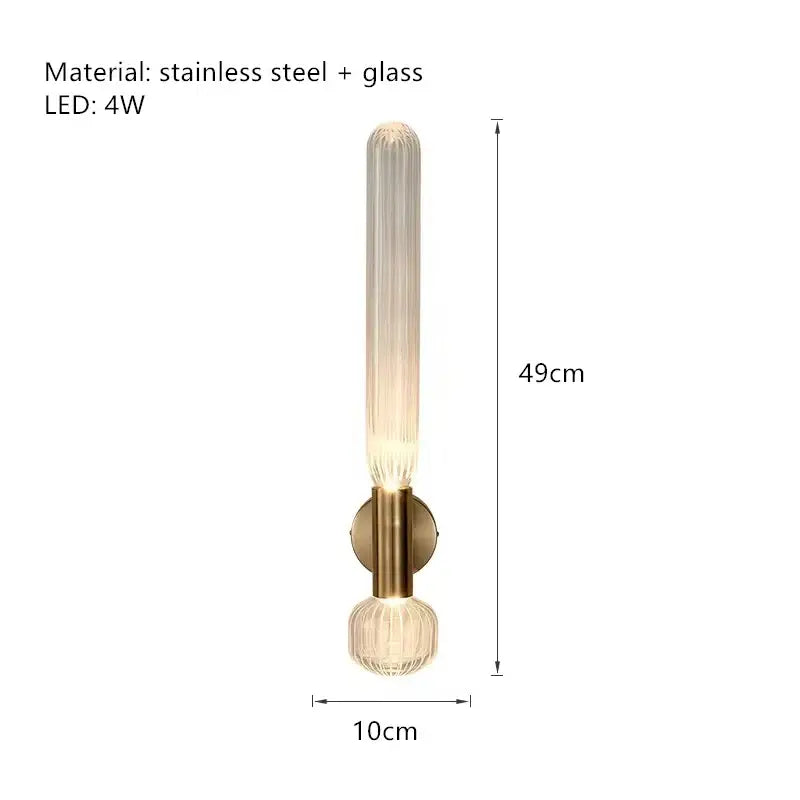 A modern wall-mounted sconce with slender ribbed glass tubes and a brushed brass fixture by decorbites glass tubes led collection