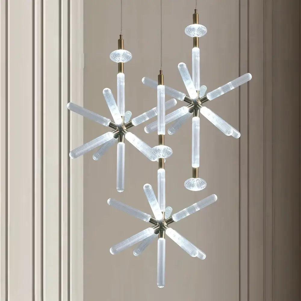 Modern starburst chandelier with clear ribbed glass tubes and brass accents from DecorBites glass tubes led collection