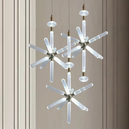 Modern starburst chandelier with clear ribbed glass tubes and brass accents from DecorBites glass tubes led collection