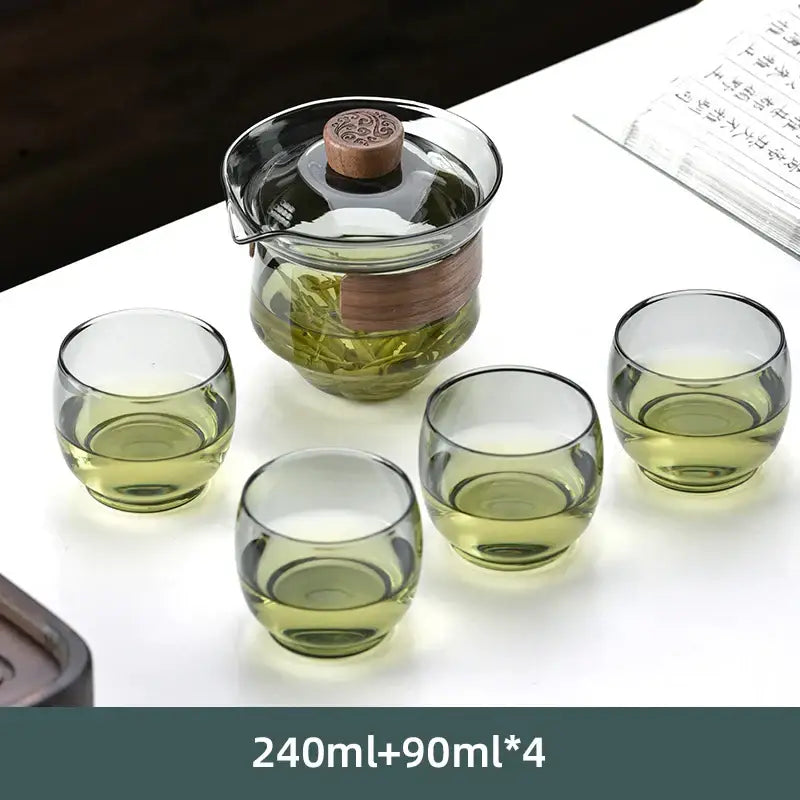 Clear glass DecorBites glass tureen teapot with wooden lid and handle, paired with four green-tinted glass kung fu tea cups