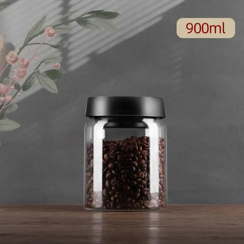 DecorBites glass vacuum sealed jar with black lid filled with dark brown coffee beans for home kitchen storage