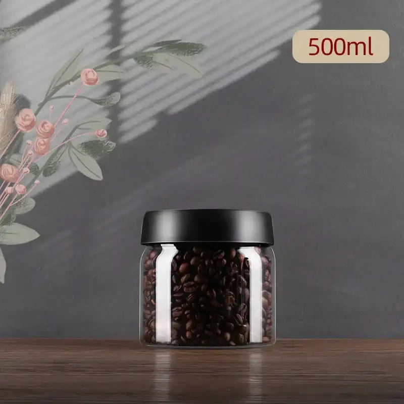 Clear glass jar with black lid filled with dark brown coffee beans from decorbites glass vacuum sealed canister