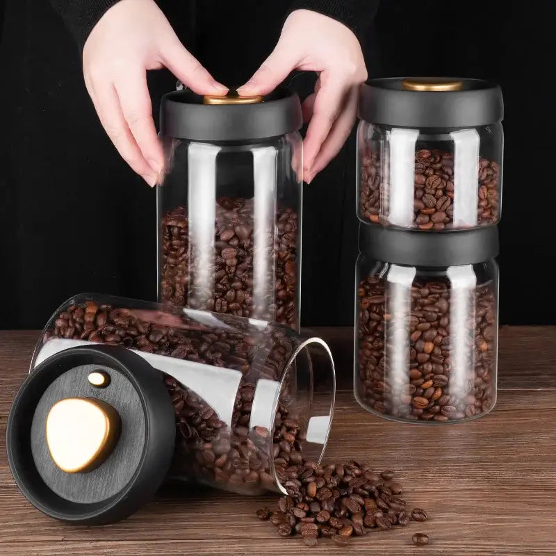 Clear glass vacuum sealed coffee beans storage jars with black matte lids and gold-toned accents decorbites glass vacuum