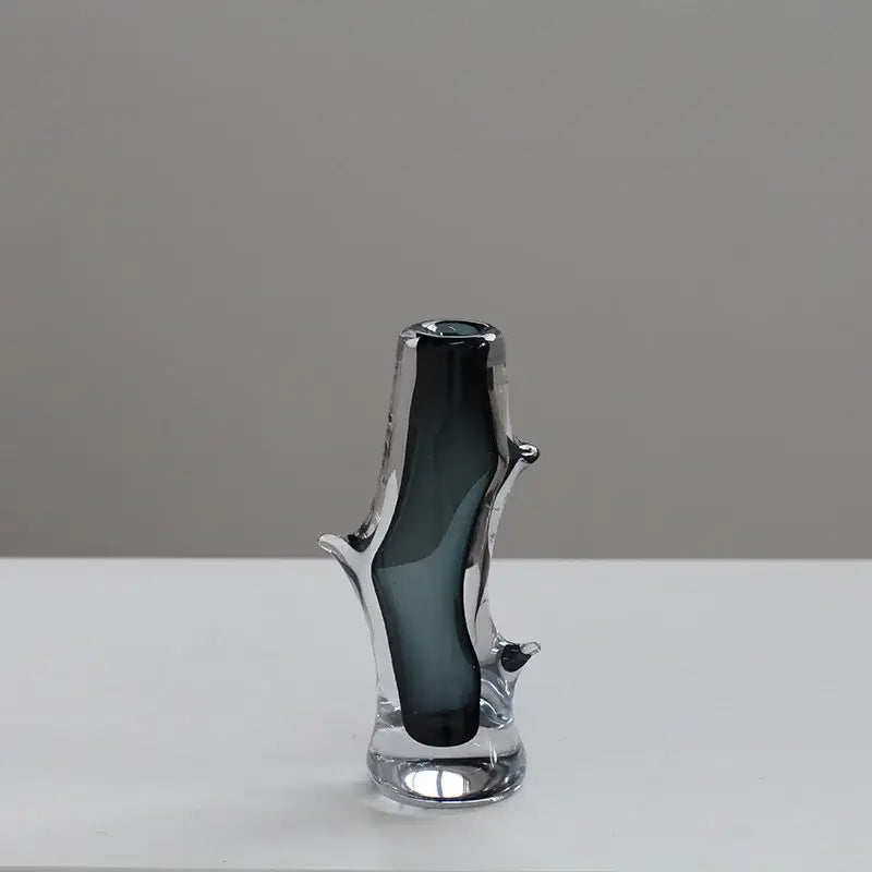 A sleek dark gray DecorBites glass vase with transparent base and branching tree like structure for floral arrangement