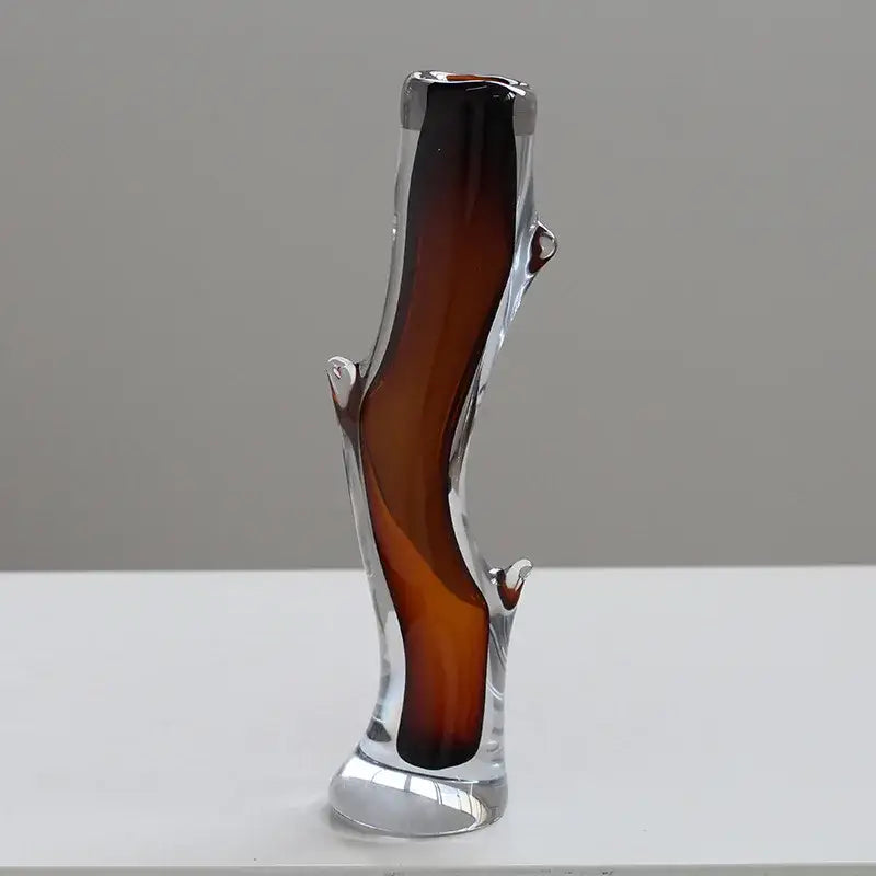 A sleek decorbites glass vase with amber gradient and sculpted branch details for floral arrangement or terrarium