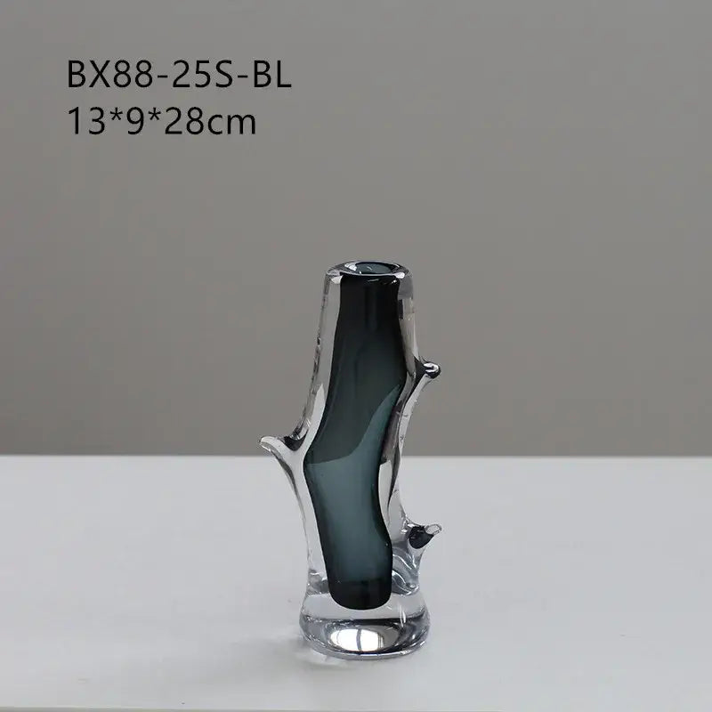 A sleek dark gray decorbites glass vase with a transparent branch design and reflective base for floral arrangement