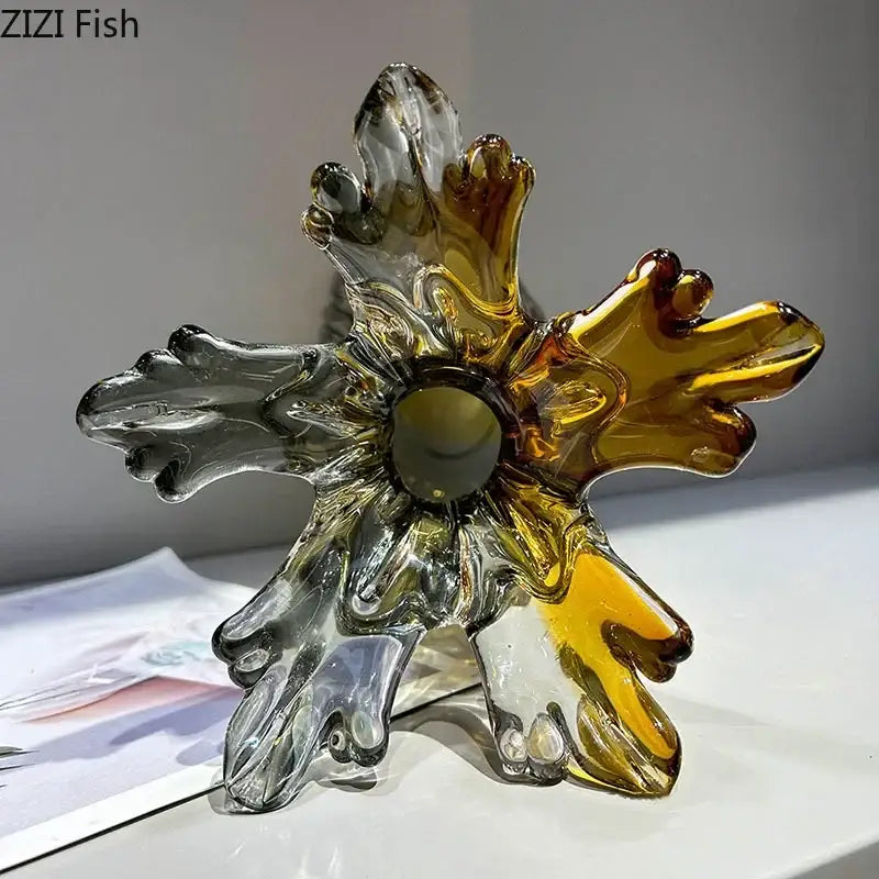 Translucent hand-blown decorbites glass vase shaped like a six-pointed star with swirling amber and clear sections
