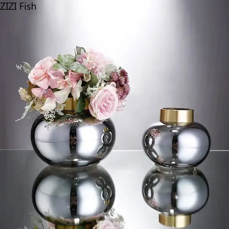 Shiny silver DecorBites glass vase with gold rim holding pink and white artificial flowers for desk decor
