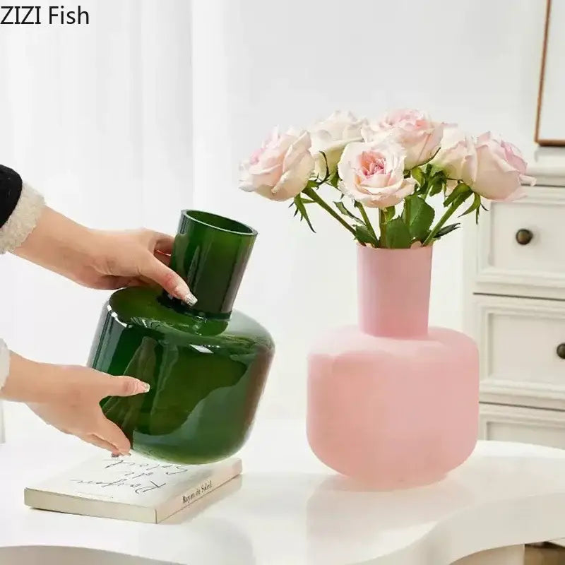 A glossy emerald green decorbites glass vase with a wide body and narrow neck for artificial flowers desk decor