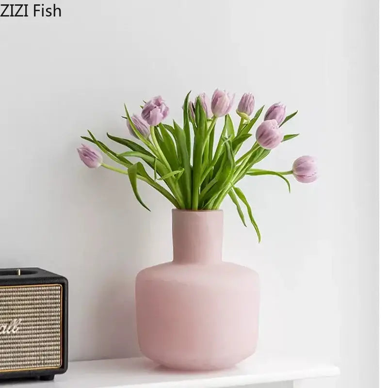A soft pink decorbites glass vase desk pot with artificial purple tulips for modern aesthetic decor