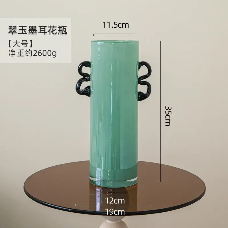 Decorbites glass vase in translucent mint green with black twisted handles for flower arrangement and home decoration