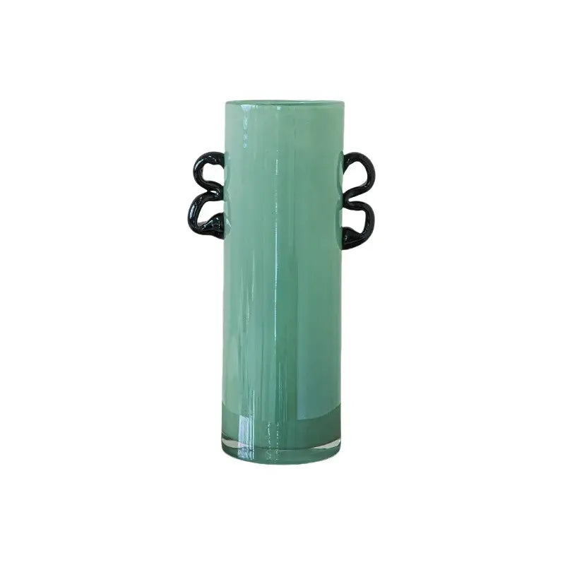 A sleek translucent mint-green decorbites glass vase with elegant black twisted handles for flower arrangement