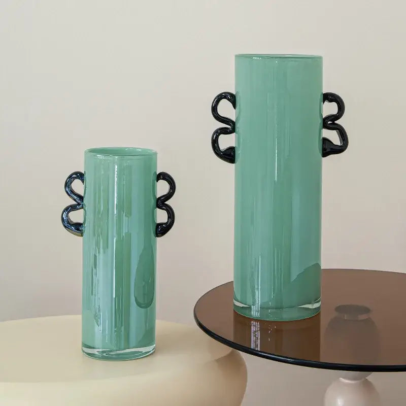 Tall translucent mint-green decorbites glass vase with sleek black twisted handles for home decoration and terrariums