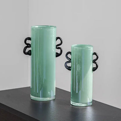 Two mint-green decorbites glass vases with black twisted handles for flower arrangement and home decoration