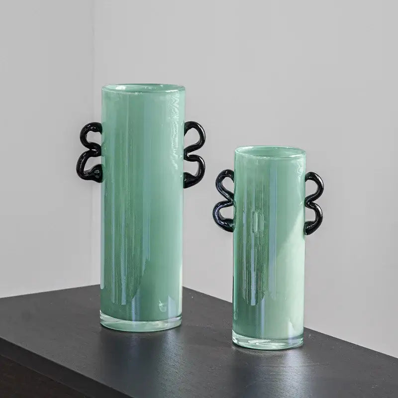 Two mint-green decorbites glass vases with black twisted handles for flower arrangement and home decoration