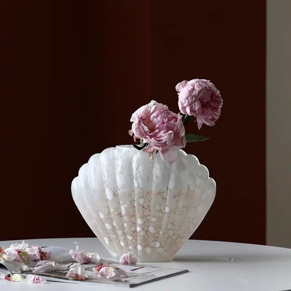 A translucent white DecorBites glass vase with a pebble texture holds delicate pink peonies for home decor