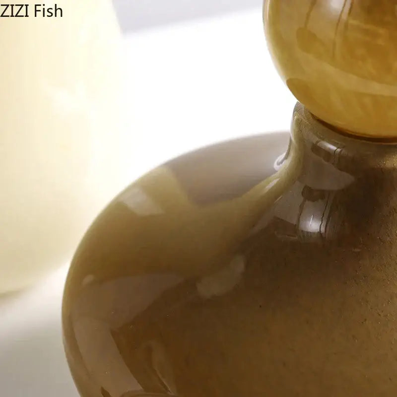 A translucent amber glass vase with a rounded body and spherical stopper for decorbites glass vase flower arrangement