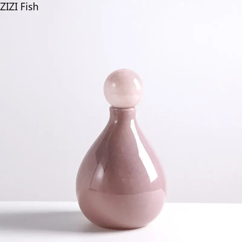 A sleek matte pink ceramic decorbites glass vase with a rounded stopper for glass vase flower arrangement decor
