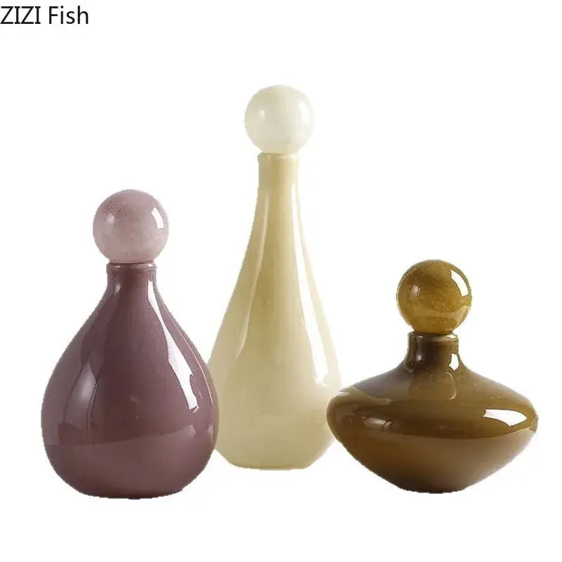 Three elegant glossy ceramic perfume bottles in muted purple cream and amber complement decorbites glass vase flower decor