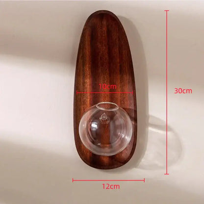 A sleek dark brown wooden decorbites glass vase wall flowerpot with an integrated clear glass sphere for plants