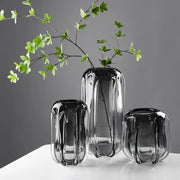 Set of three sleek translucent black decorbites glass vases with ridged texture for hydroponics and flower arrangement