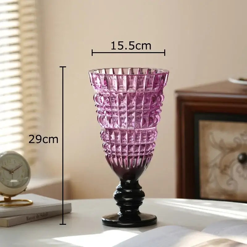A tall elegant purple decorbites glass vase with black base and geometric cut patterns for hydroponics plant pot