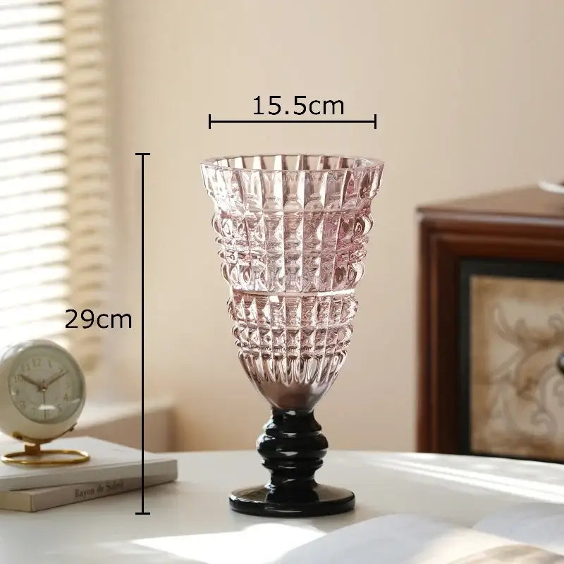 Decorbites glass vase featuring a tall translucent pink glass body with a black base for hydroponics and decor