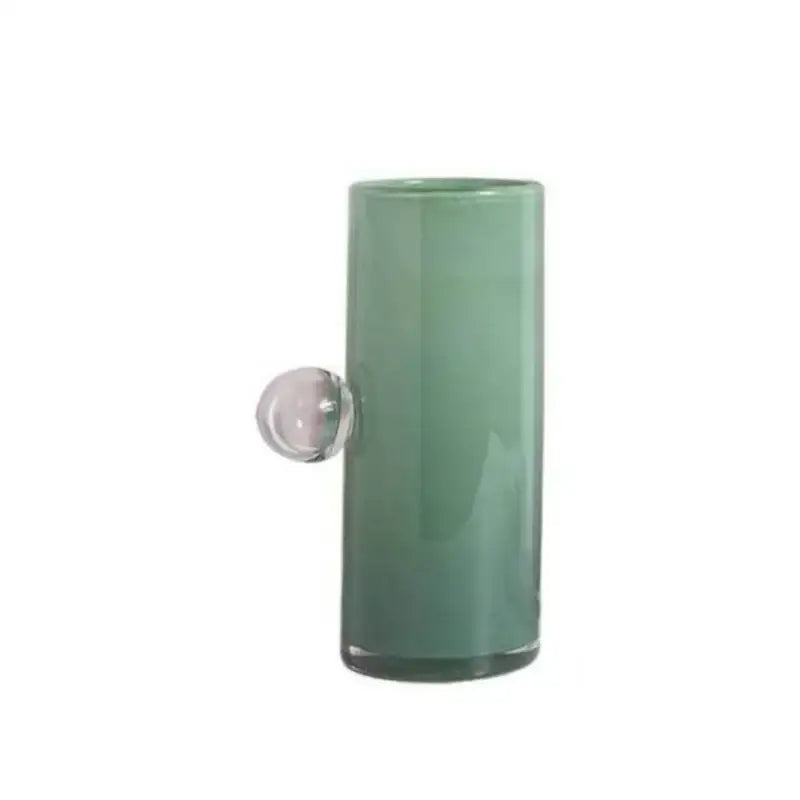 A sleek matte sage green decorbites glass vase geometric with a clear spherical handle for flowers and accessories