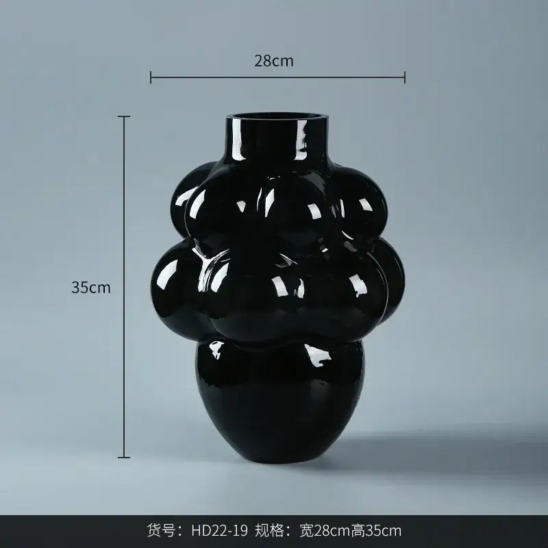 A sleek glossy black ceramic decorbites glass vase featuring a modern grape geometric sculptural design for home decor