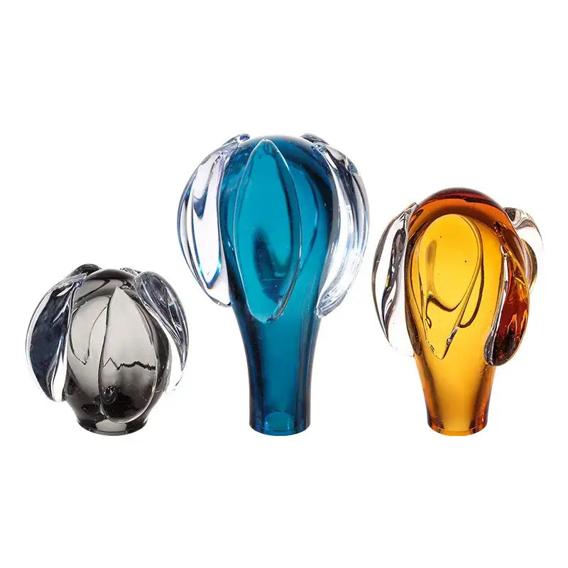 Three translucent glass sculptures in gray blue and amber with leaf-like appendages for DecorBites glass vase hot air decor