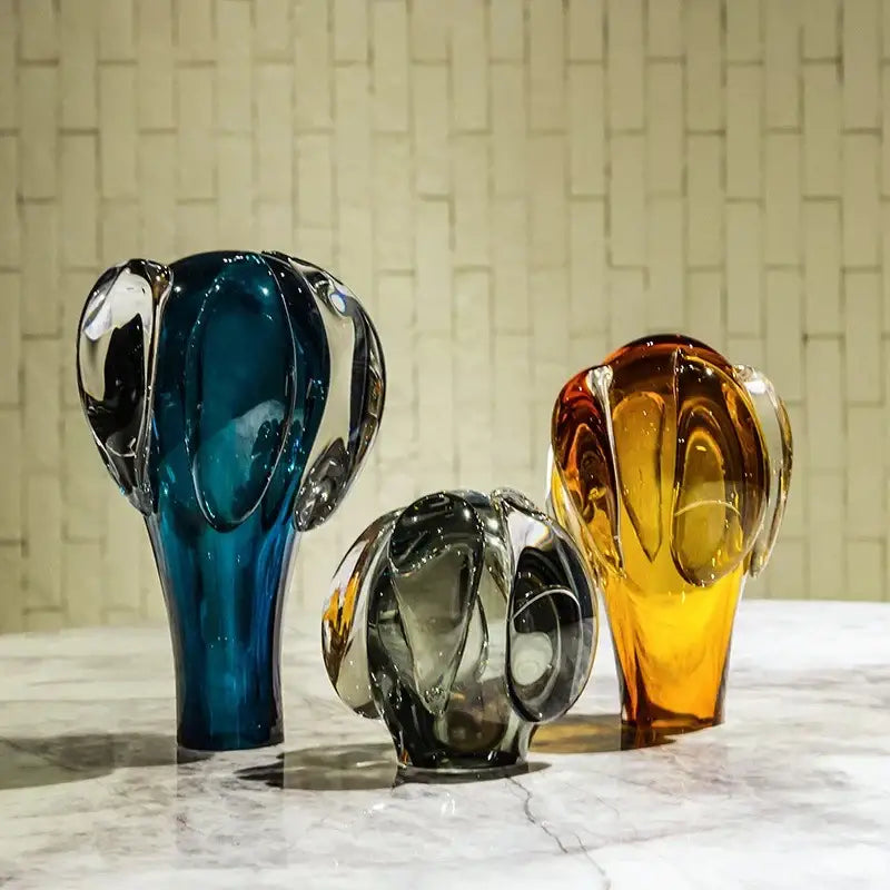 Three abstract decorbites glass vase hot air balloon accessory in vibrant blue amber and translucent gray glass with smooth curves