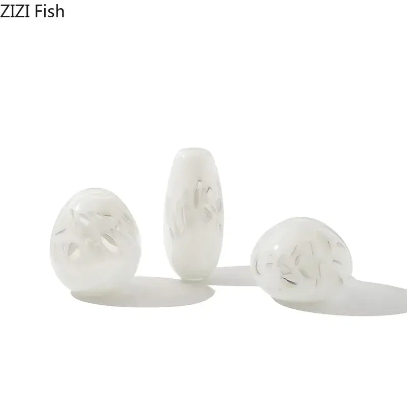 Three translucent white glass beads with etched leaf patterns featured in decorbites glass vase for elegant decor